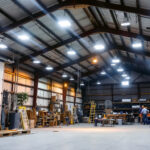 A photograph of a well-lit pole barn interior showcasing various lighting options
