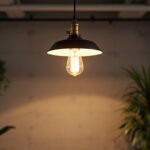 A photograph of a stylish industrial ceiling lamp installed in a modern workspace