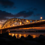 A photograph of a beautifully illuminated bridge at dusk