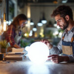 A photograph of a lighting contractor installing or showcasing a variety of modern led lamps in a well-lit