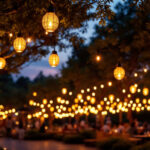 A photograph of a beautifully illuminated outdoor space featuring solar pendant lights hanging from trees or structures