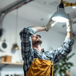 A photograph of a skilled lighting contractor expertly installing a lighting fixture without the use of wire connectors