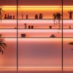 A photograph of a beautifully lit interior space featuring vibrant tape lights installed along shelves or architectural features