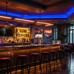 A photograph of a stylish bar area illuminated by sleek