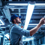 A photograph of a brightly lit workspace featuring various types of fluorescent lights in use
