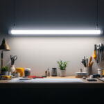 A photograph of a well-lit workspace featuring a u-shaped fluorescent tube prominently displayed