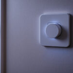 A photograph of a modern electrical wall socket installed in a stylish interior setting