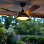 A photograph of a stylish metal outdoor ceiling fan installed in a beautifully lit outdoor space