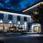 A photograph of a commercial outdoor setting showcasing a well-lit building exterior illuminated by various styles of led wall pack lights