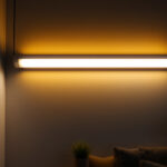 A photograph of a modern fluorescent light fixture installed in a stylish interior setting