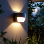 A photograph of a beautifully designed solar-powered wall sconce mounted on an exterior wall