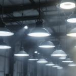 A photograph of a well-lit industrial space showcasing various high bay light fixtures in action