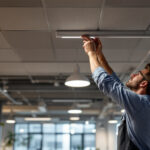 A photograph of a modern office space featuring sleek led ceiling lights in action