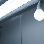 A photograph of a side-by-side comparison of a fluorescent light fixture and an led replacement
