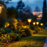 A photograph of a beautifully illuminated outdoor path featuring solar-powered lights