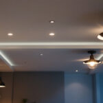 A photograph of a well-lit basement ceiling featuring various stylish and functional lighting fixtures