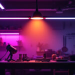 A photograph of a well-lit workshop or garage featuring dimmable led shop lights in action