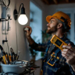 A photograph of a lighting contractor in action