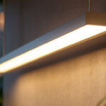 A photograph of a modern strip light fixture installed in a stylish and well-lit interior space
