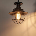 A photograph of a stylish industrial flush mount light fixture installed in a modern interior setting