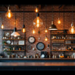 A photograph of a stylish industrial space featuring a variety of unique lighting fixtures