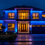 A photograph of a beautifully illuminated house featuring striking blue lights
