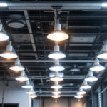A photograph of a modern lighting installation that prominently features 277v fixtures in an industrial or commercial setting