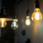 A photograph of a well-lit interior space featuring various lamps with different types of light bulbs