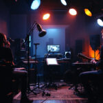 A photograph of a well-lit studio recording setup