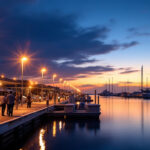 A photograph of a well-lit dock scene at dusk