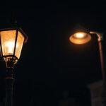A photograph of a vintage street lamp post juxtaposed with a modern led street light