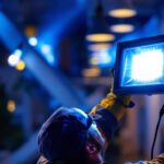 A photograph of a lighting contractor installing flood light leds in a commercial or residential setting