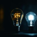 A photograph of a vintage light bulb alongside a modern led bulb