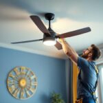 A photograph of a lighting contractor efficiently installing a stylish ceiling fan in a well-lit