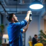 A photograph of a lighting contractor installing sleek