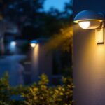 A photograph of a well-lit outdoor area featuring security lights with motion detectors in action