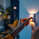 A photograph of a lighting contractor expertly installing a modern dimming switch in a stylish home setting
