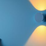A photograph of a stylish wall lamp fixture elegantly illuminating a modern interior space