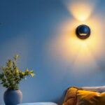 A photograph of a beautifully designed wall sconce illuminating a cozy room