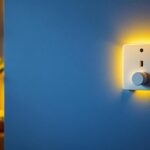 A photograph of a modern plug wall cover installed in a stylish interior setting