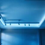 A photograph of a well-lit room featuring a drop ceiling with track lighting installed