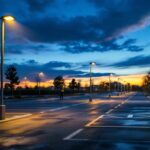 A photograph of a well-lit parking lot at dusk