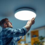 A photograph of a lighting contractor expertly installing wafer recessed lighting in a modern home setting