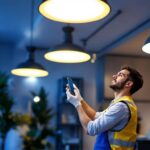 A photograph of a lighting contractor installing or showcasing high hat led fixtures in a modern interior setting