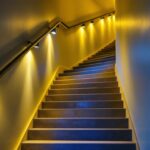 A photograph of a well-lit basement stairway