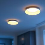 A photograph of a well-lit modern living space showcasing three stylish recessed can lights installed in the ceiling