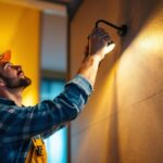 A photograph of a lighting contractor in action
