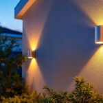 A photograph of a beautifully illuminated exterior wall featuring stylish wall-mounted lights
