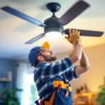 A photograph of a skilled lighting contractor expertly replacing a ceiling fan