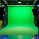 A photograph of a well-lit green screen setup in a studio environment